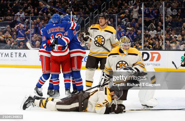 Artemi Panarin of the New York Rangers celebrates his second of three goals against the Boston Bruins with his teammates Alexis Lafreniere and Alex...