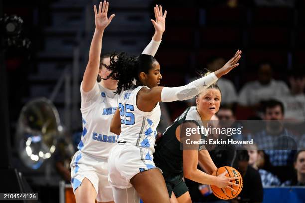 Theryn Hallock of the Michigan State Spartans looks for a pass against Deja Kelly and Alyssa Ustby of the North Carolina Tar Heels in the second...