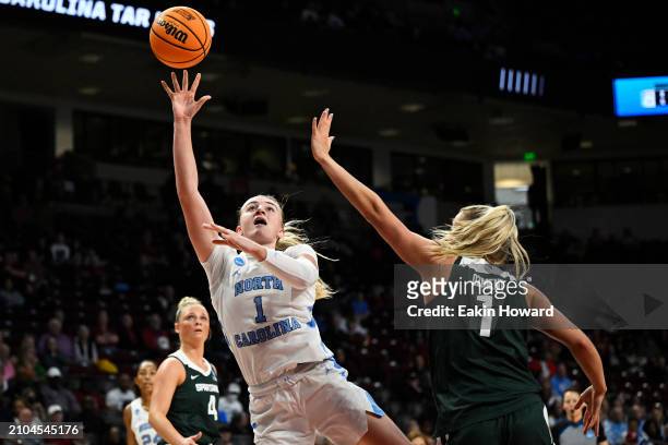 Alyssa Ustby of the North Carolina Tar Heels shoots against Tory Ozment of the Michigan State Spartans in the second quarter during the first round...