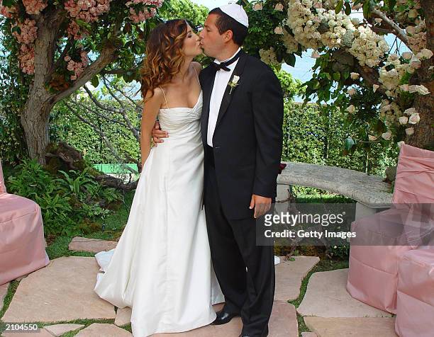 In this handout photo, Adam Sandler poses with his bride model-actress Jackie Titone at their wedding June 22, 2003 in Malibu, California.