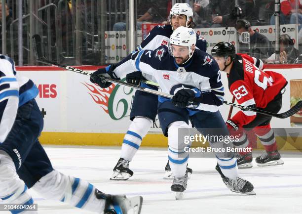 Dylan DeMelo of the Winnipeg Jets skates against the New Jersey Devils at Prudential Center on March 21, 2024 in Newark, New Jersey.