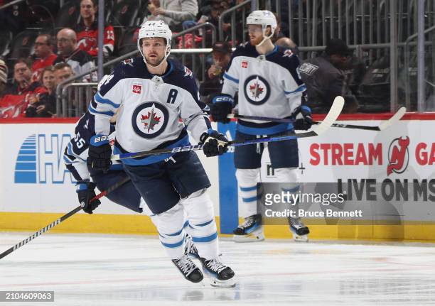 Josh Morrissey of the Winnipeg Jets skates against the New Jersey Devils at Prudential Center on March 21, 2024 in Newark, New Jersey.