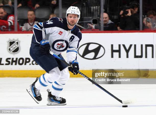 Josh Morrissey of the Winnipeg Jets skates against the New Jersey Devils at Prudential Center on March 21, 2024 in Newark, New Jersey.