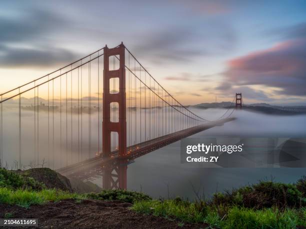 fog over golden gate bridge at sunrise from battery spencer (marin headlands) - battery spencer stock pictures, royalty-free photos & images