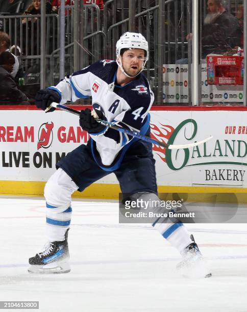 Josh Morrissey of the Winnipeg Jets skates against the New Jersey Devils at Prudential Center on March 21, 2024 in Newark, New Jersey.