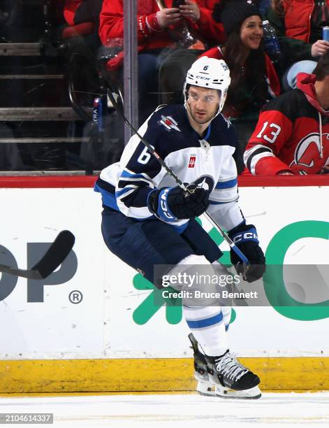 Colin Miller of the Winnipeg Jets skates against the New Jersey Devils at Prudential Center on March 21, 2024 in Newark, New Jersey.