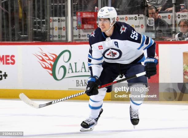 Mark Scheifele of the Winnipeg Jets skates against the New Jersey Devils at Prudential Center on March 21, 2024 in Newark, New Jersey.