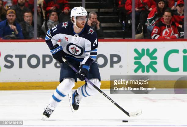 Kyle Connor of the Winnipeg Jets skates against the New Jersey Devils at Prudential Center on March 21, 2024 in Newark, New Jersey.