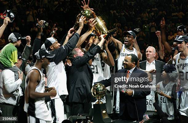 The San Antonio Spurs hold the 2003 NBA Finals Champtionshiop Trophy after defeating the New Jersey Nets in Game six of the 2003 NBA Finals at SBC...