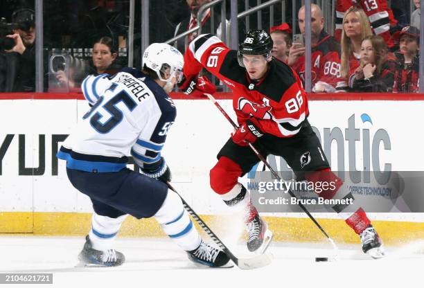 Jack Hughes of the New Jersey Devils skates against the Winnipeg Jets at Prudential Center on March 21, 2024 in Newark, New Jersey.