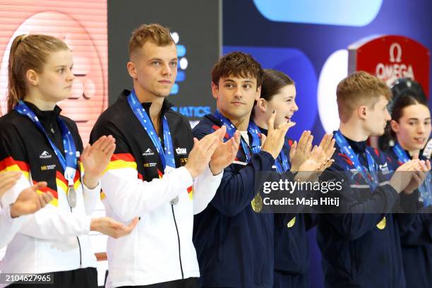 Gold Medalist, Thomas Daley of Team Great Britain reacts with his medal after competing in the Mixed Team Event during the World Aquatics Diving...