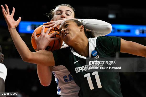 Alyssa Ustby of the North Carolina Tar Heels catches a rebound against Jocelyn Tate of the Michigan State Spartans in the third quarter during the...