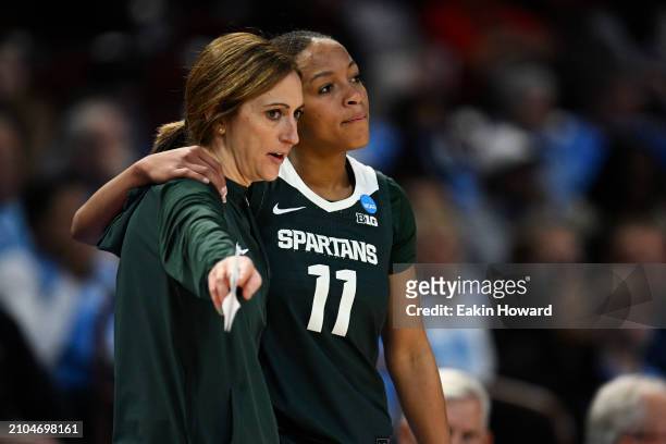 Head coach Robyn Fralick speaks with Jocelyn Tate of the Michigan State Spartans against the North Carolina Tar Heels in the third quarter during the...