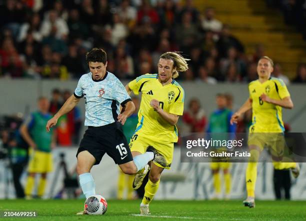 Joao Neves of Portugal with Emil Forsberg of Sweden in action during the International Friendly match between Portugal and Sweden at Estadio D....