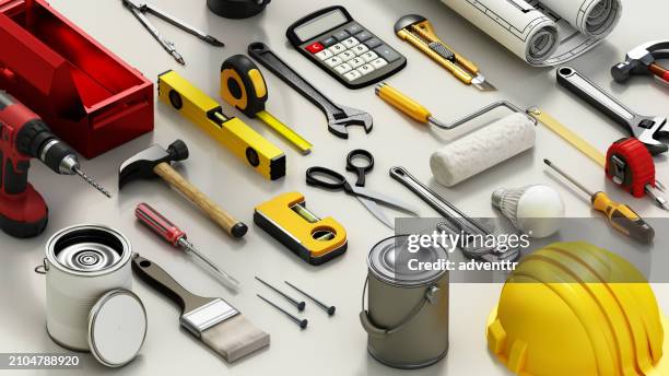 assorted construction tools spread out on a white surface during daytime - hammer wrench stock pictures, royalty-free photos & images