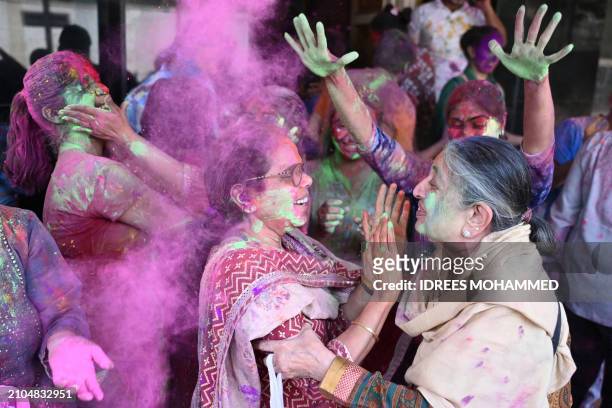 Women celebrate Holi, the Hindu spring festival of colours, in Bengaluru on March 25, 2024.