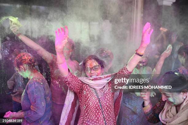 Women celebrate Holi, the Hindu spring festival of colours, in Bengaluru on March 25, 2024.