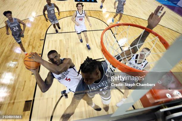 Lamont Butler of the San Diego State Aztecs drives to the basket against Christian Coleman of the UAB Blazers during the first half in the first...