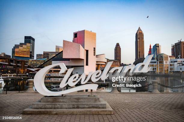 cleveland script sign at dusk - lake erie cleveland ohio stock pictures, royalty-free photos & images