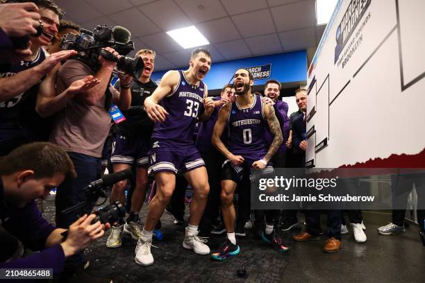 Boo Buie and Luke Hunger of the Northwestern Wildcats celebrate in the locker room after defeating the Florida Atlantic Owls during the first round...