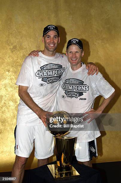 Danny Ferry and Steve Kerr of the San Antonio Spurs pose with the 2003 NBA Championship trophy after defeating the New Jersey Nets in Game six of the...