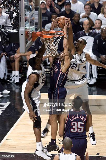 David Robinson and Tim Duncan of the San Antonio Spurs block a shot by Richard Jefferson of the New Jersey Nets during Game six of the 2003 NBA...