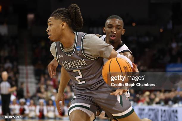 Lamont Butler of the San Diego State Aztecs attempts to steal the ball from Daniel Ortiz of the UAB Blazers during the second half in the first round...