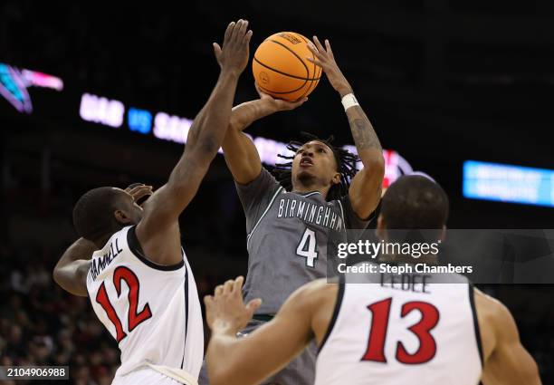 Eric Gaines of the UAB Blazers shoots the ball against Darrion Trammell of the San Diego State Aztecs during the second half in the first round of...