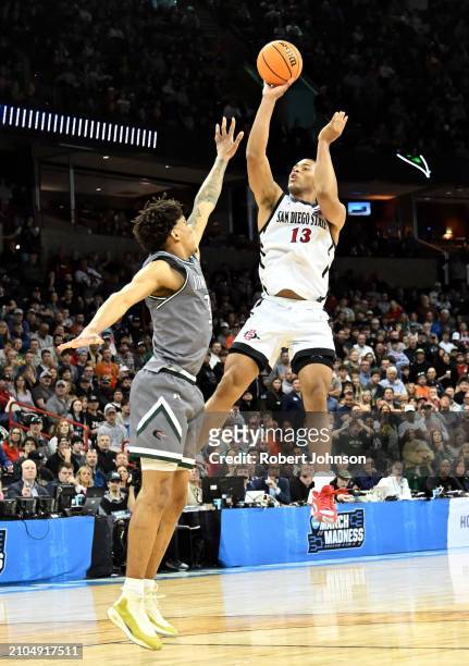Jaedon LeDee of the San Diego State Aztecs shoots the ball against Yaxel Lendeborg of the UAB Blazers during the second half in the first round of...