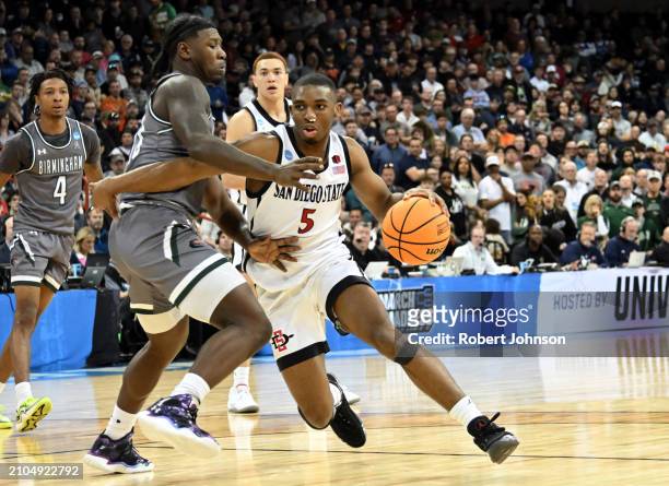 Lamont Butler of the San Diego State Aztecs drives to the basket against Alejandro Vasquez of the UAB Blazers during the second half in the first...