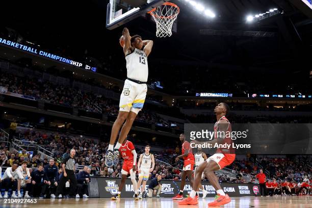 Oso Ighodaro of the Marquette Golden Eagles dunks the ball against the Western Kentucky Hilltoppers during the second half in the first round of the...