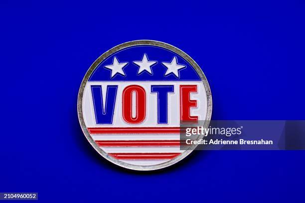 single “vote” button on blue background - enamel badge stock pictures, royalty-free photos & images