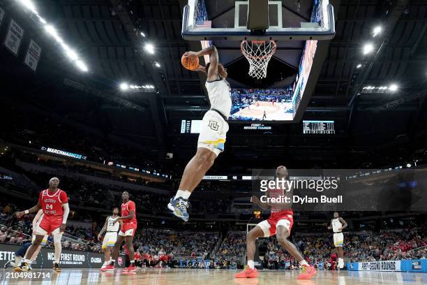 Oso Ighodaro of the Marquette Golden Eagles dunks the ball against the Western Kentucky Hilltoppers during the second half in the first round of the...