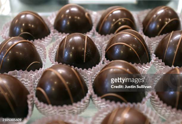 Chocolates are displayed on a shelf at Celine's Sweets on March 22, 2024 in Novato, California. Cocoa futures prices have more than doubled since the...