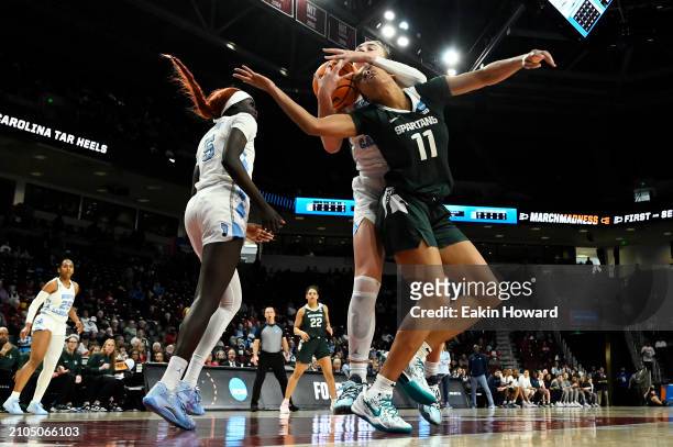 Alyssa Ustby of the North Carolina Tar Heels catches a rebound against Jocelyn Tate of the Michigan State Spartans in the third quarter during the...