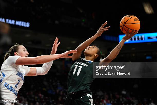 Jocelyn Tate of the Michigan State Spartans attempts a basket against Alyssa Ustby of the North Carolina Tar Heels in the third quarter during the...