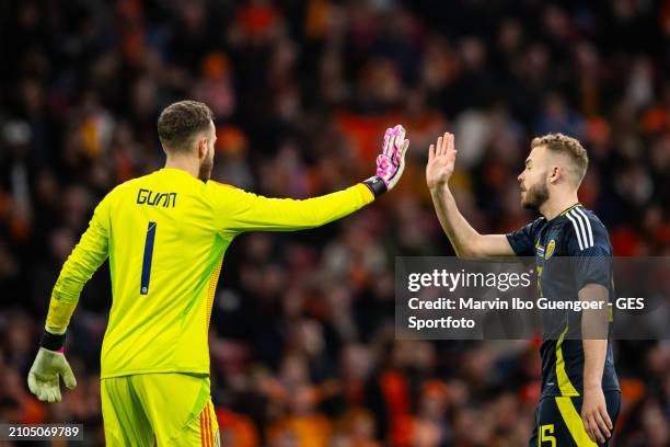Angus Gunn and Ryan Porteous of Scotland high five each other during the friendly match between Netherlands and Scotland at Johan Cruyff Arena on...