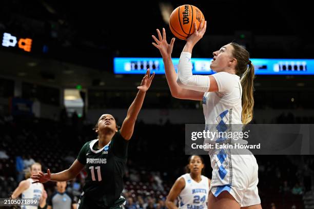 Alyssa Ustby of the North Carolina Tar Heels attempts a basket against Jocelyn Tate of the Michigan State Spartans in the first quarter during the...
