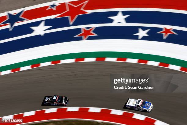 Ty Dillon, driver of the Rackley Roofing Chevrolet, and Stefan Parsons, driver of the Springrates Chevrolet, drive during practice for the NASCAR...