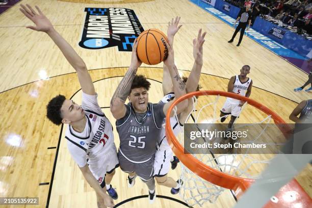 Will Shaver of the UAB Blazers drives to the basket against Miles Heide and Miles Byrd of the San Diego State Aztecs during the second half in the...