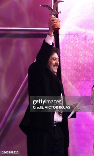 Spanish composer José María Purón holds his trophy for his song "Este amor es tuyo" 25 February during the final night of the 44th Vina del Mar Music...