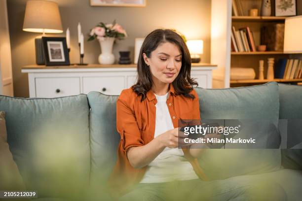 happy girl competing in smartphone video games online with friends - friends laughing at iphone video stock pictures, royalty-free photos & images