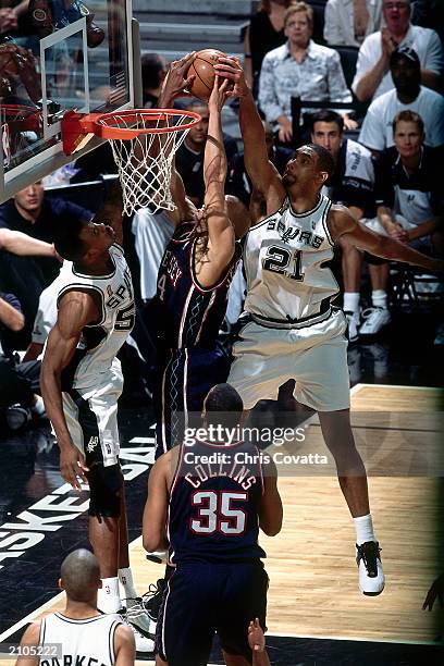 Tim Duncan and David Robinson of the San Antonio Spurs block the shot by Richard Jefferson of the New Jersey Nets during Game six of the 2003 NBA...