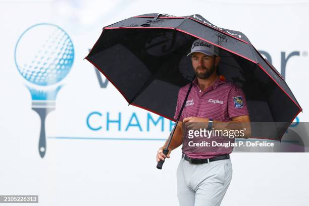 Cameron Young of the United States looks on under an umbrella on the 18th green during the second round of the Valspar Championship at Copperhead...