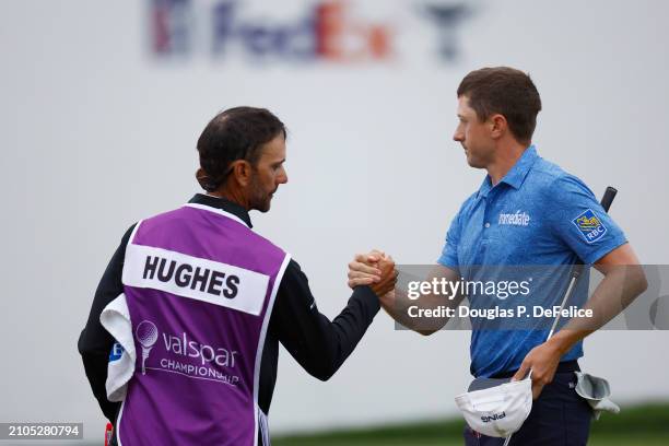 Mackenzie Hughes of Canada and his caddie shake hands on the 18th green during the second round of the Valspar Championship at Copperhead Course at...