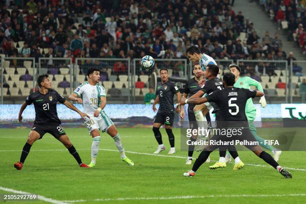 Aissa Mandi of Algeria scores his team's third goal under pressure from Guillermo Viscarra Bruckner of Bolivia during the FIFA Series 2024 Algeria...