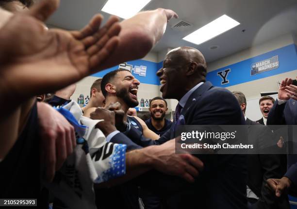 Head coach James Jones of the Yale Bulldogs celebrates with his team in the locker room after a 78-76 victory against the Auburn Tigers in the first...