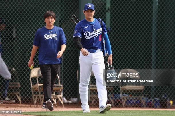 Shohei Ohtani of the Los Angeles Dodgers and interpreter Ippei Mizuhara arrive to a game against the Chicago White Sox at Camelback Ranch on February...