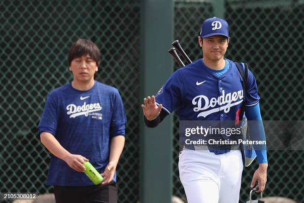 Shohei Ohtani of the Los Angeles Dodgers and interpreter Ippei Mizuhara arrive to a game against the Chicago White Sox at Camelback Ranch on February...