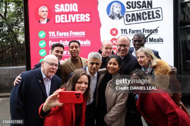 Mayor of London Sadiq Khan poses with his team in front of the launching of a new poster campaign, in central London, on March 25, 2024 ahead of the...